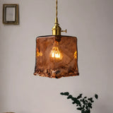 Amber glass pendant light with a rectangular shade and adjustable hanging cord