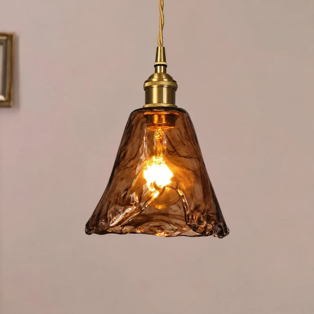 Close-up of the textured amber glass shade and metal fitting on a pendant light