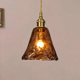 Close-up of the textured amber glass shade and metal fitting on a pendant light