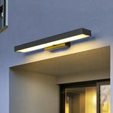 Black outdoor wall light mounted beside a front door