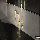 Gold cascading crystal chandelier in a double-height staircase hall