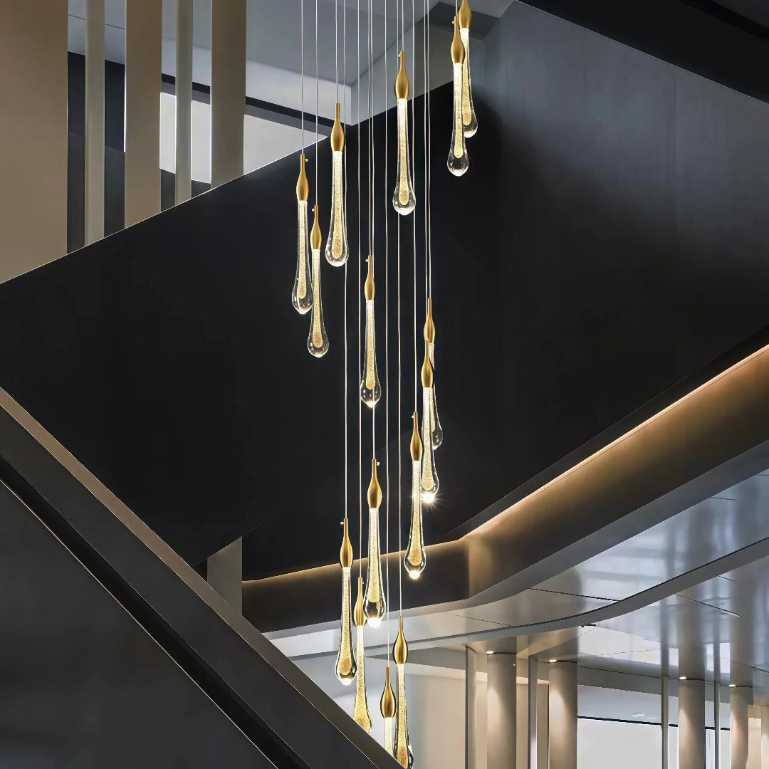 Gold teardrop crystal staircase chandelier in a contemporary stairwell