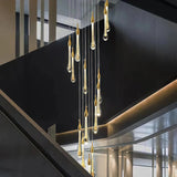 Gold teardrop crystal staircase chandelier in a contemporary stairwell