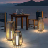 Boho outdoor floor lantern with a woven rattan-style shade