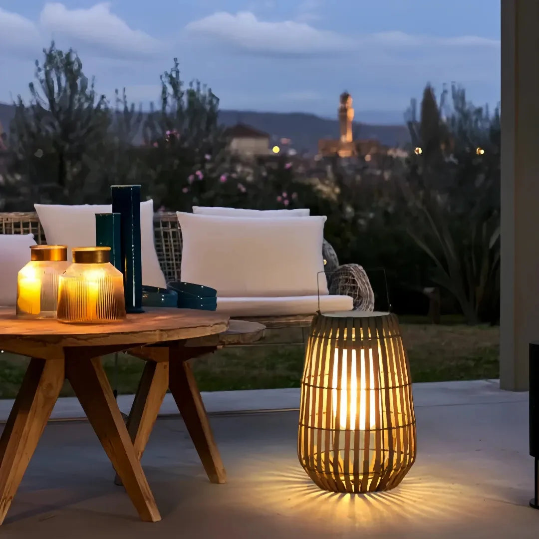 Solar outdoor floor lantern glowing beside patio seating