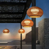 Side view of a round rattan outdoor pendant light