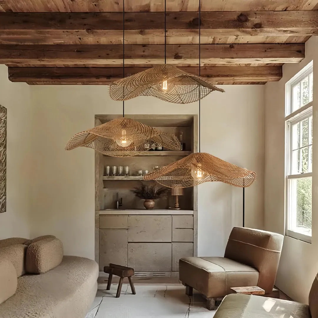 Three-light wave rattan pendant in a living room with a timber-beam ceiling