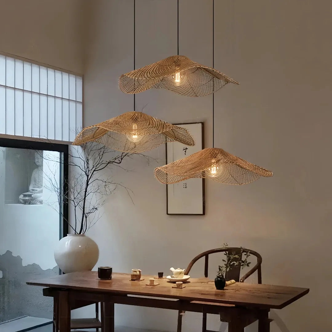 Three wave rattan pendant shades above a wooden table