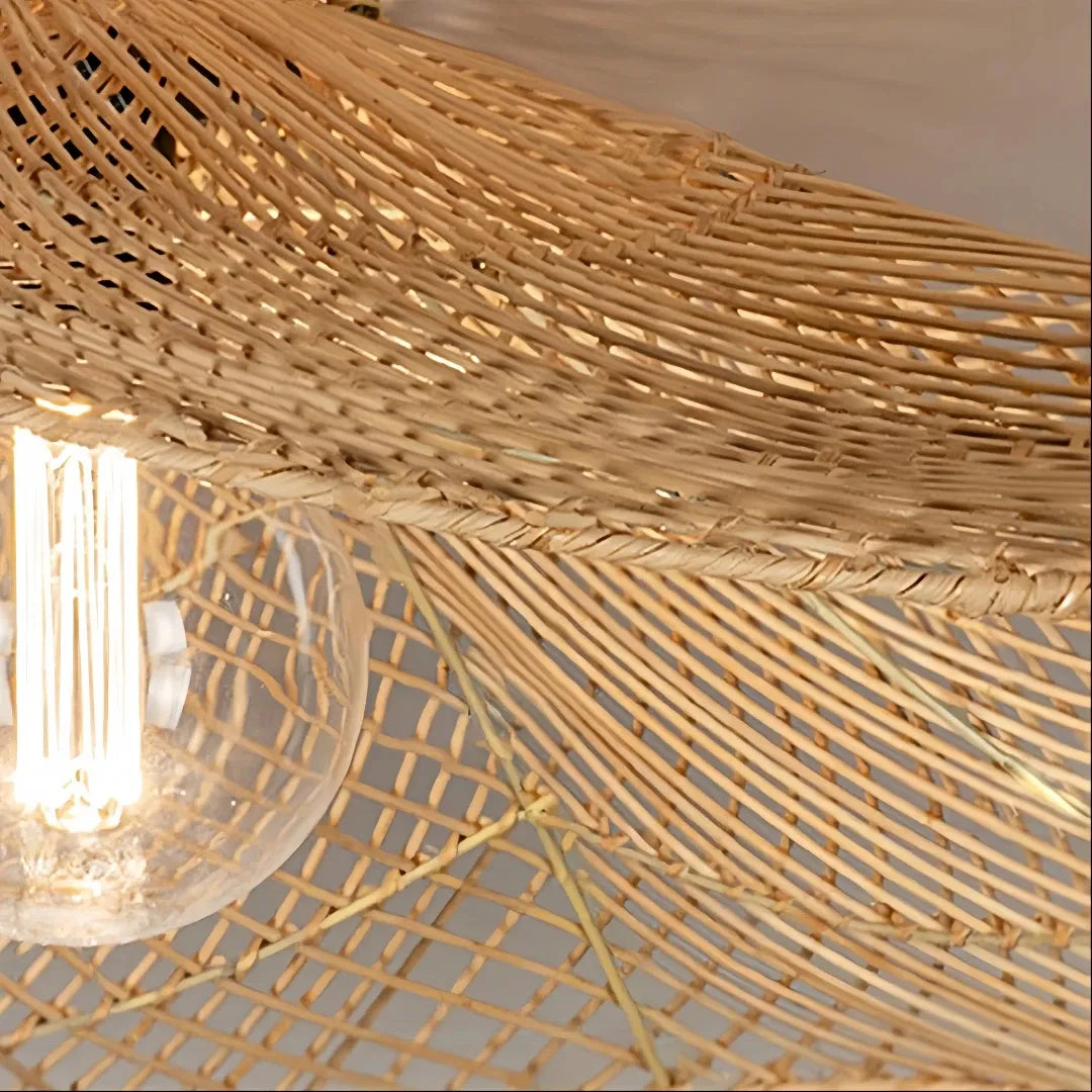 Close-up of the woven rattan shade and bulb beneath the wave-shaped edge