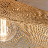 Close-up of the woven rattan shade and bulb beneath the wave-shaped edge