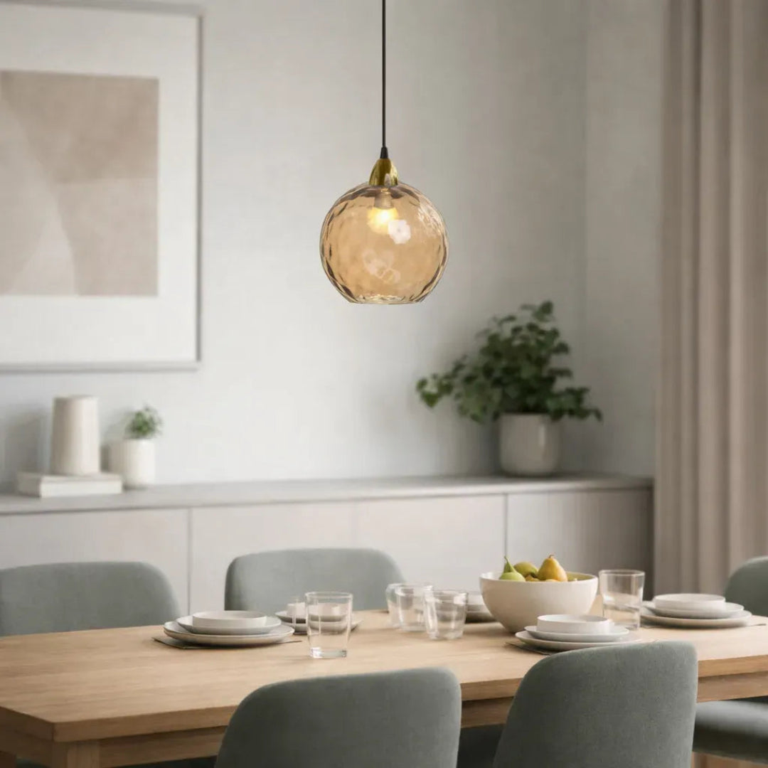 Amber glass pendant light above a dining table