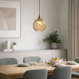 Amber glass pendant light above a dining table