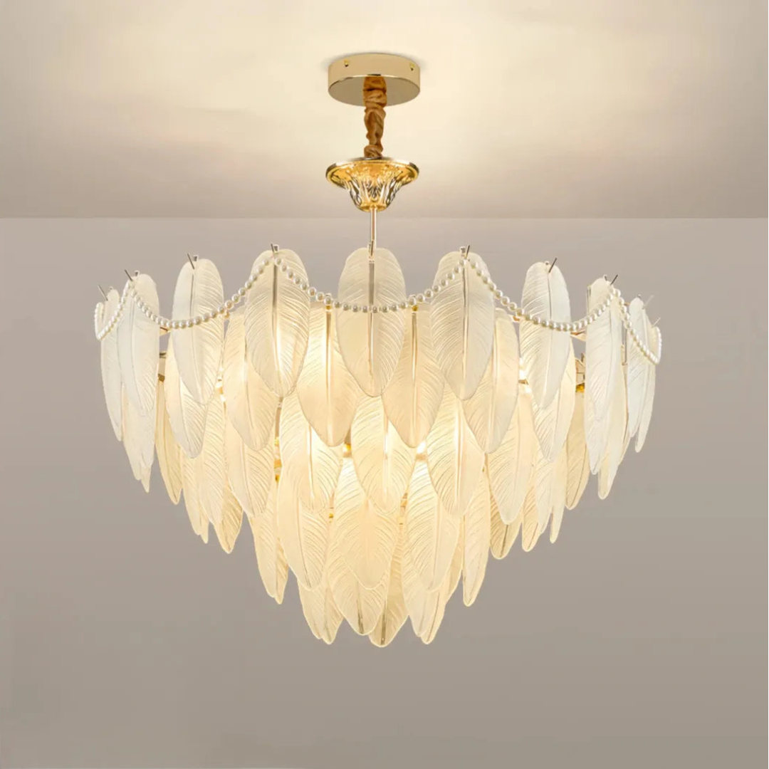 Close view of the illuminated chandelier with overlapping feather-shaped glass shades