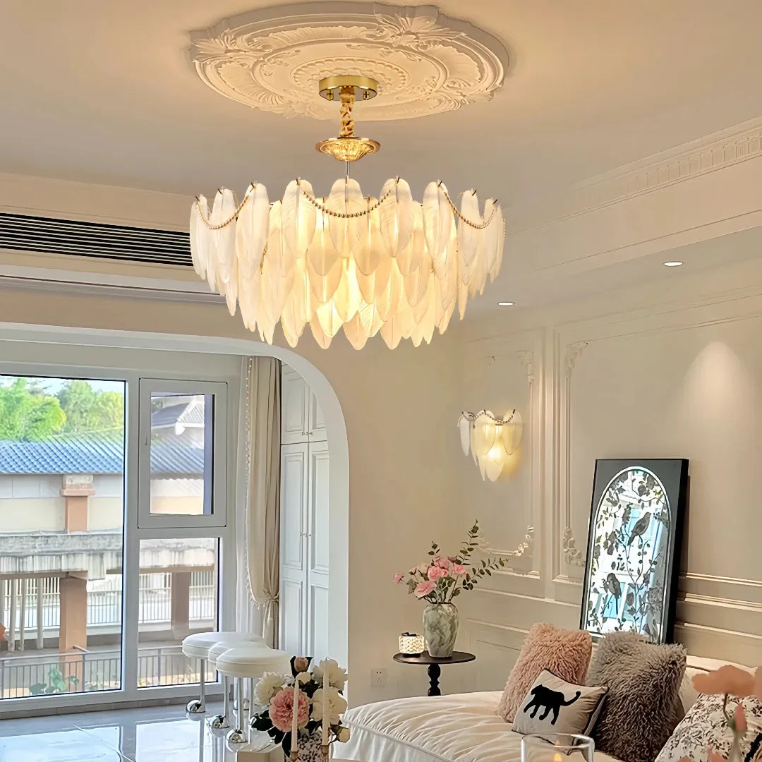 Illuminated glass feather chandelier beneath a decorative ceiling rose