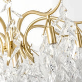 Close-up of textured crystal leaves on a gold chandelier