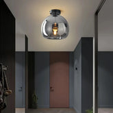 Black glass flush ceiling light in a mid-century style