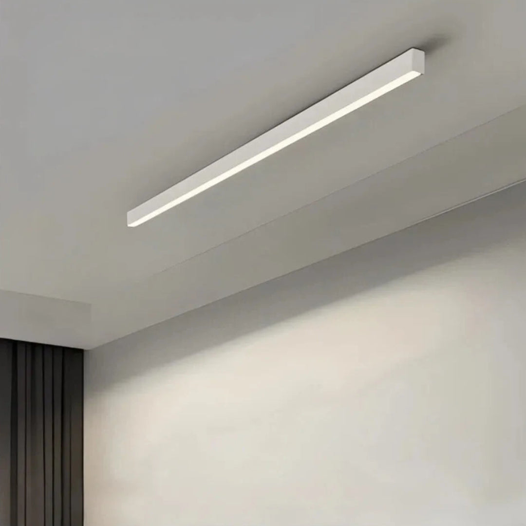 White linear flush ceiling light mounted on a pale ceiling