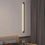 Minimalist black wall light used as ambient bedroom lighting