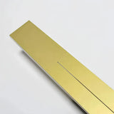 Close-up of the gold metal back plate on the linear wall light