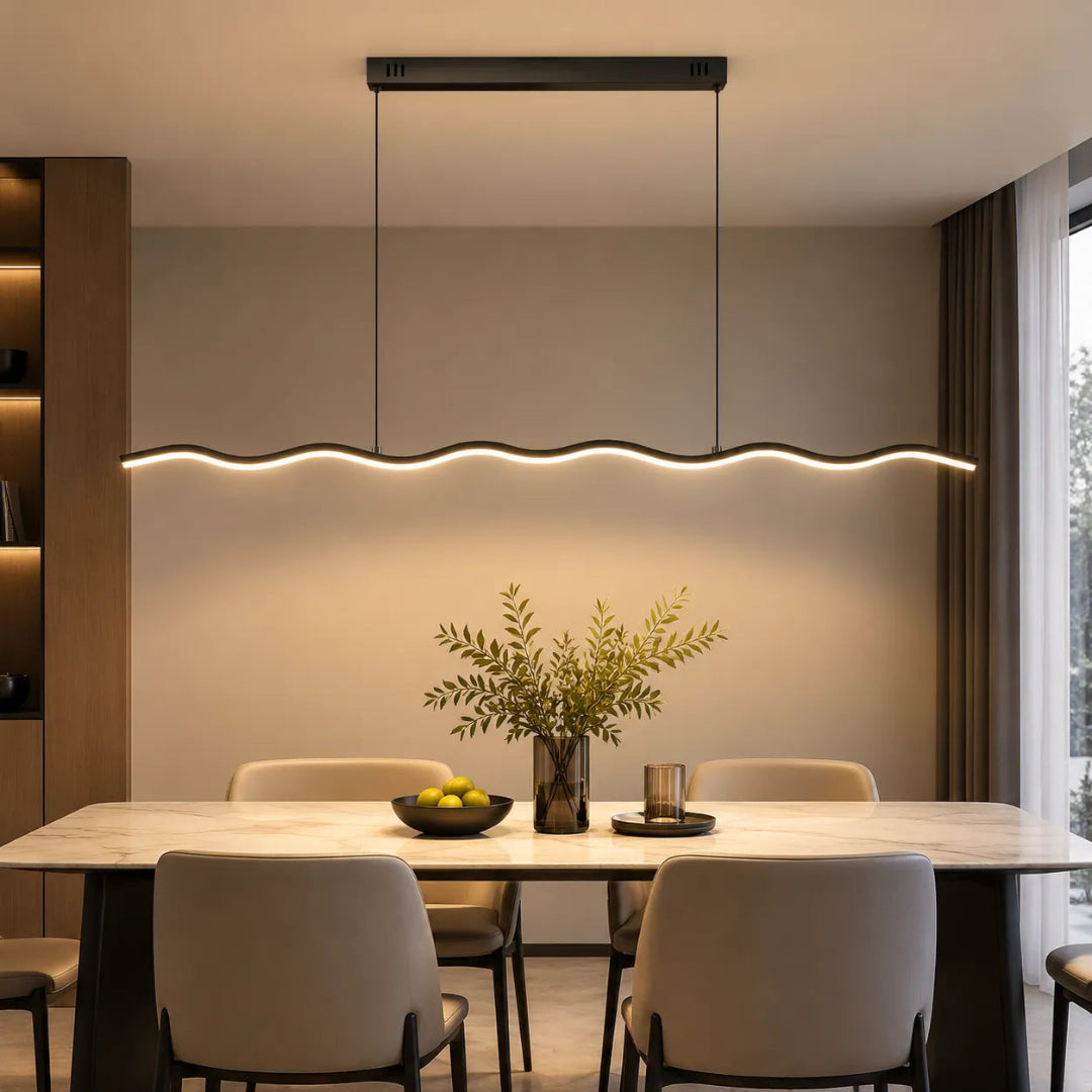 Black wave LED pendant light above a marble-effect dining table