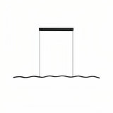 Black wave LED pendant light above a marble-effect dining table