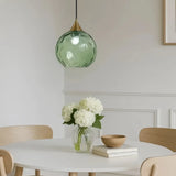 Contemporary dining room featuring a stylish coloured glass pendant light