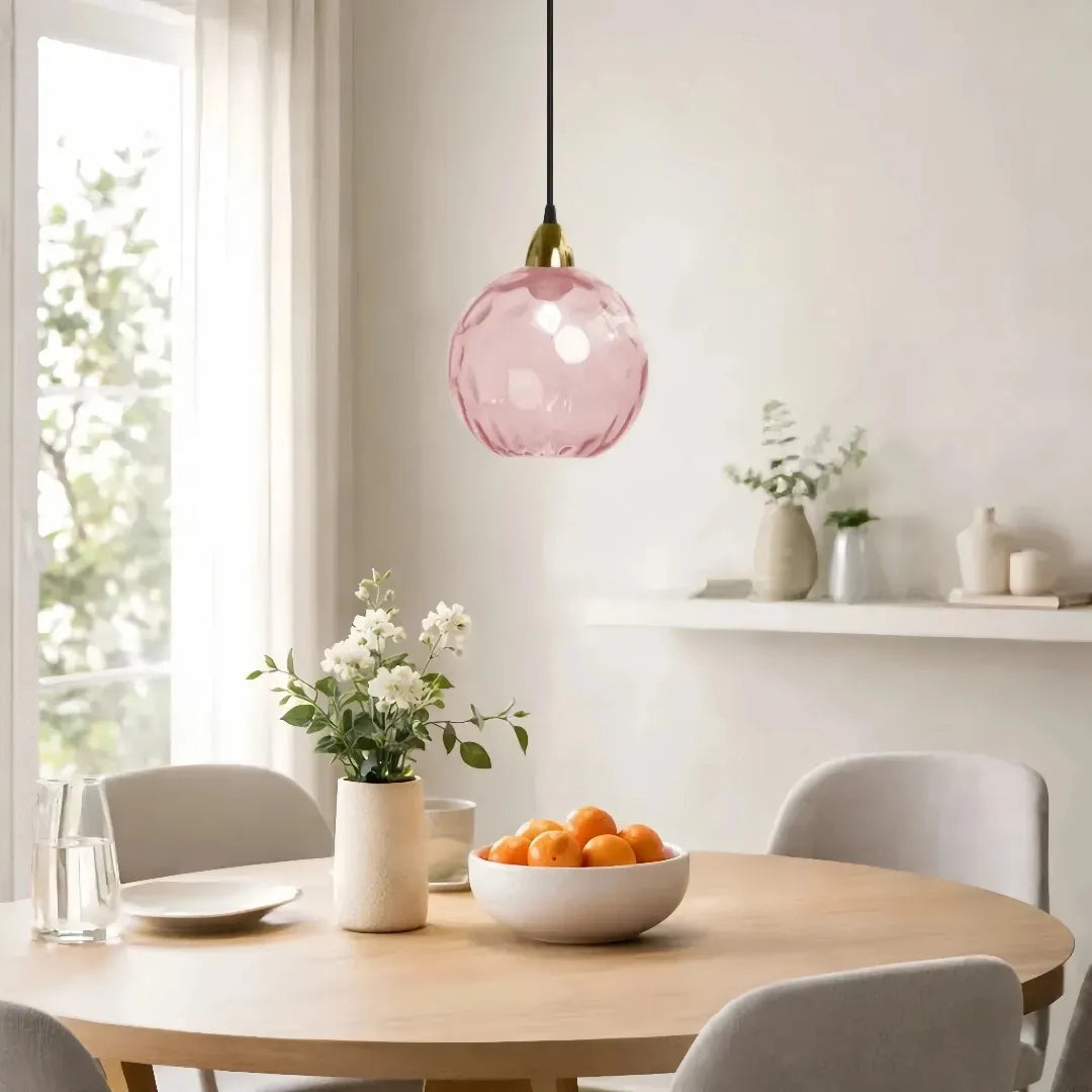 Contemporary dining room featuring a stylish coloured glass pendant light
