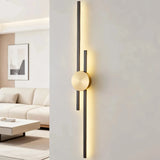 Black two-line linear LED wall light with a gold circular centre mount