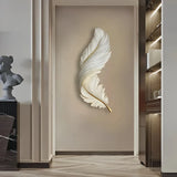 Feather-shaped LED wall light in a hallway