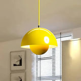 Yellow double-shade pendant light above a dining table in a contemporary dining room