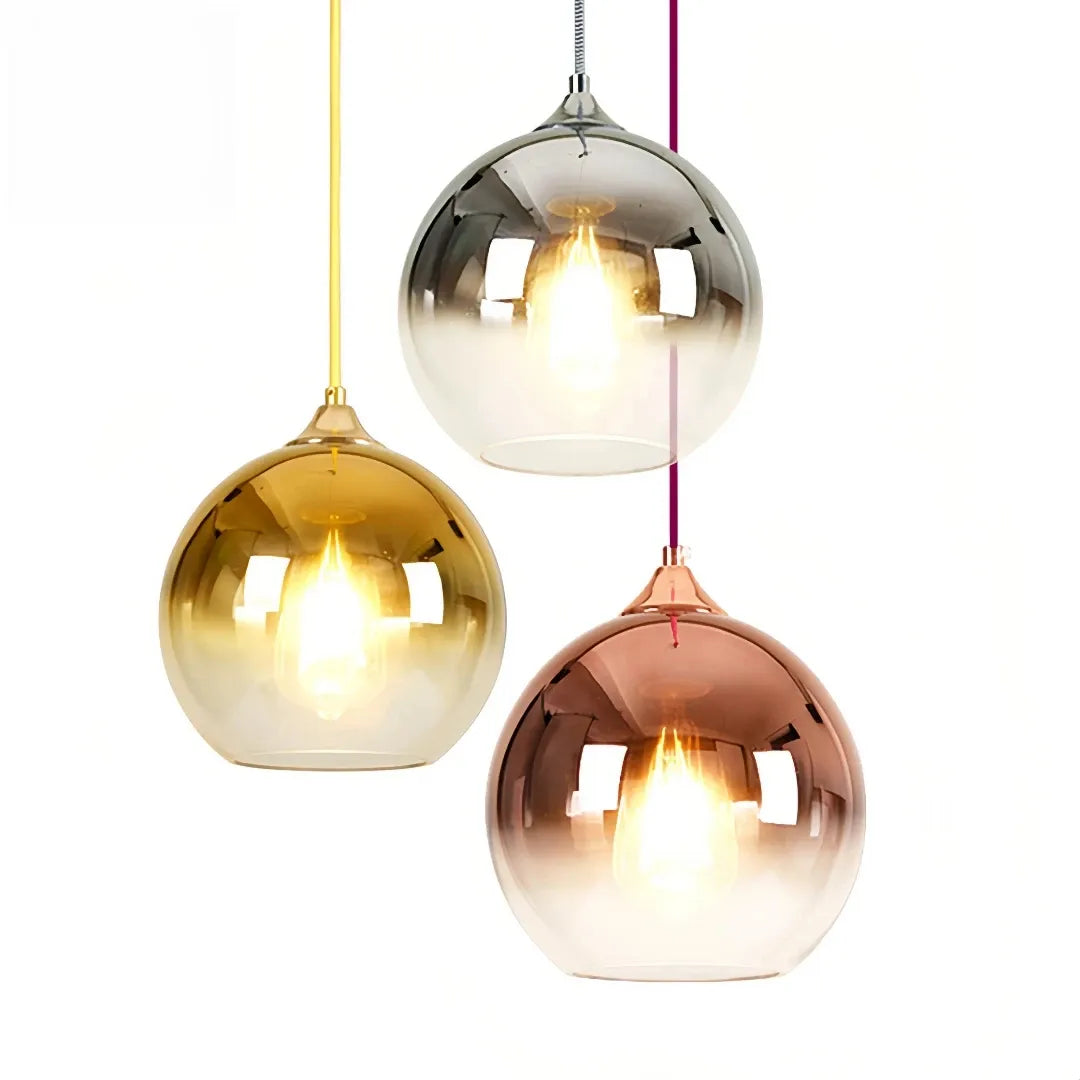 Round glass globe pendant light above a dining table
