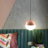 Rose gold pendant light with a frosted glass globe shade