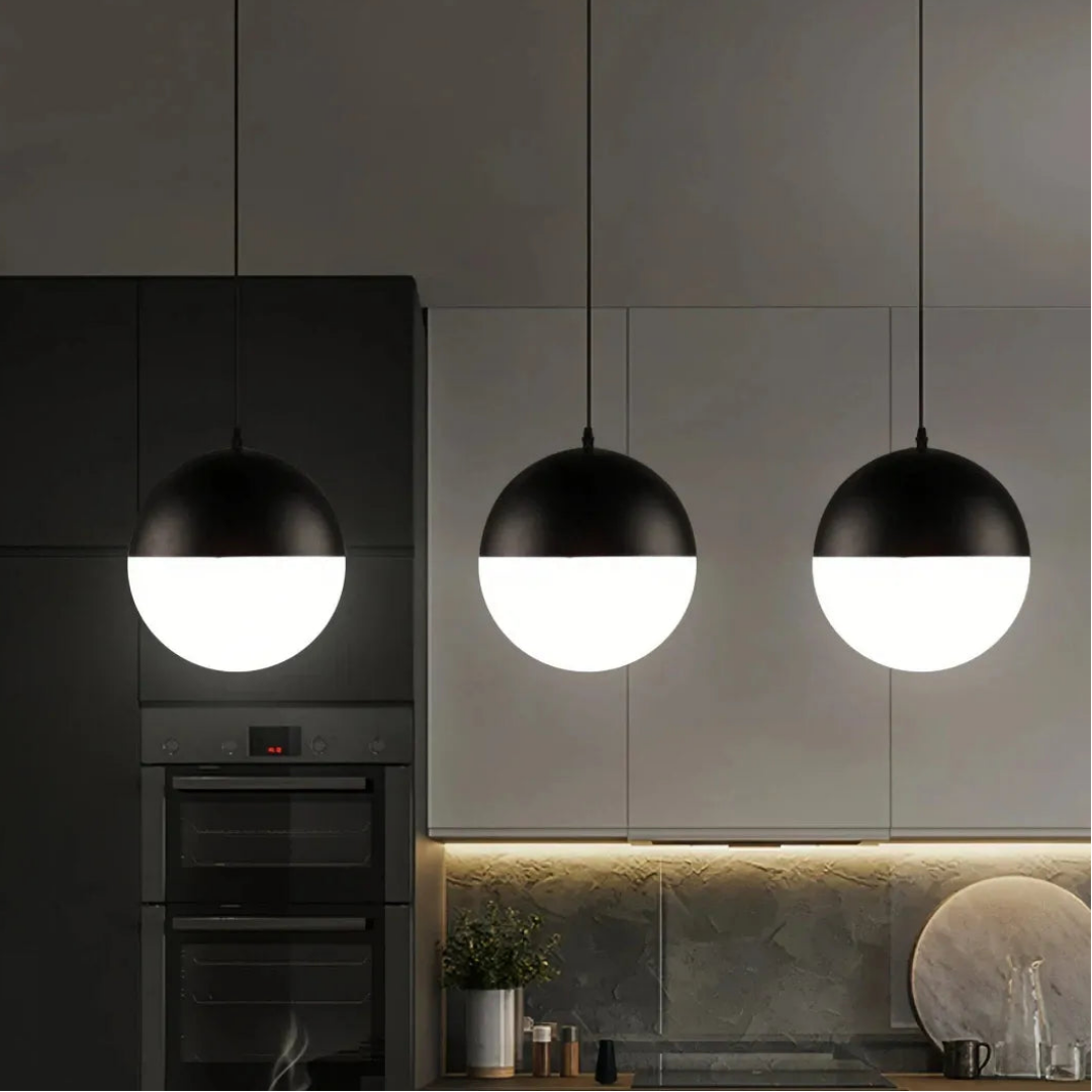 Black pendant light with a frosted glass globe shade