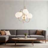Globe chandelier above a coffee table in a living room with a grey sofa