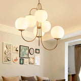 Opal glass globe chandelier in a living room with a gallery wall