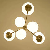 Upward view of the chandelier's six illuminated glass globe shades