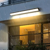Outdoor linear wall light above a planter beside a doorway