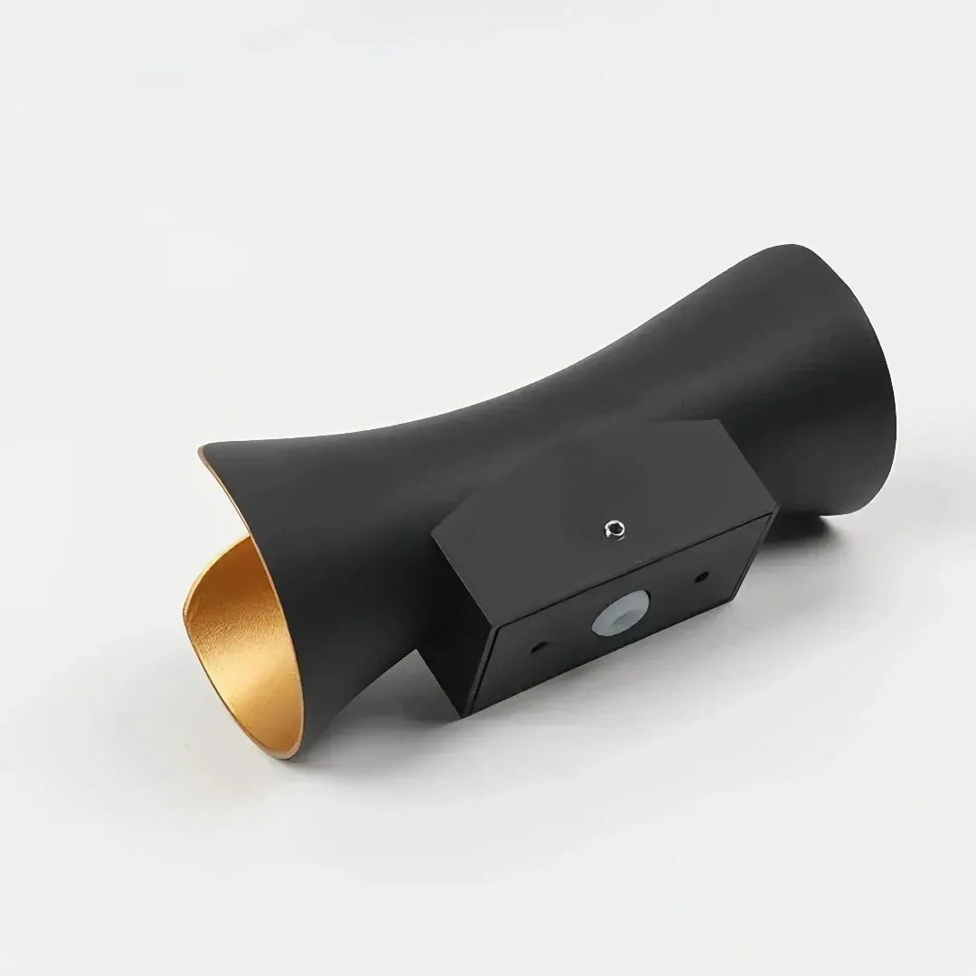 Black and gold finish on a curved outdoor wall light