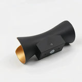 Black and gold finish on a curved outdoor wall light