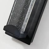 Close-up of the black metal housing and clear crystal glass panel