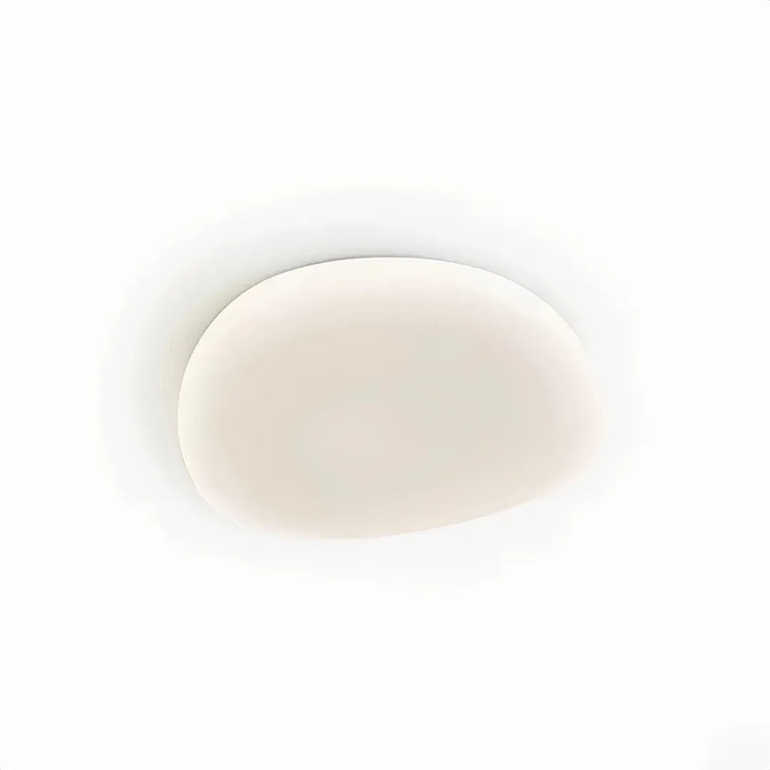 Modern white flush ceiling light installed on a bedroom ceiling