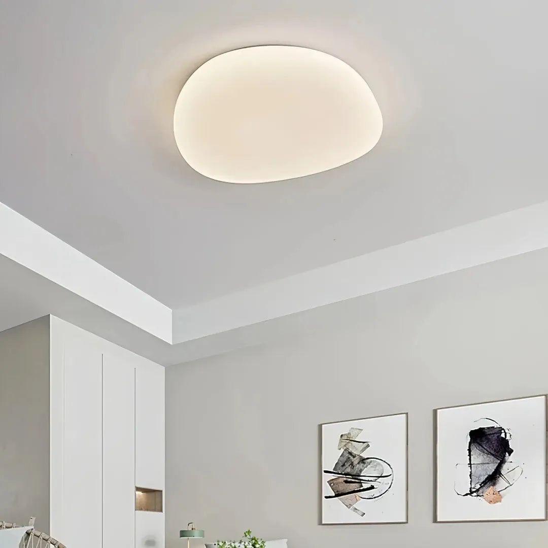 Dimmable white LED flush ceiling light illuminated in a bedroom