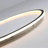 White slimline ceiling light with an illuminated circular edge