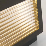 Close-up of the clear glass shade and metal frame on a garden pillar light