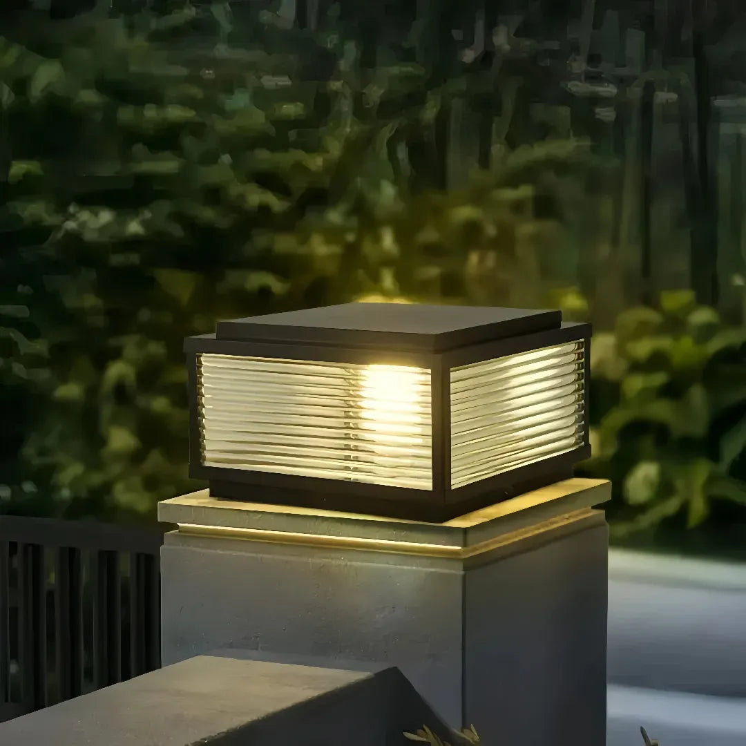Modern wired outdoor post light with clear glass shade