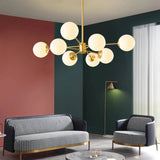 Gold 8-light chandelier with white glass globes in a living room