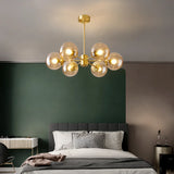 Gold 6-light chandelier with amber glass globes in a bedroom