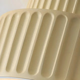 Close-up of the ribbed resin shade on a cream flush ceiling light