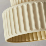Close-up of the ribbed resin shade on a cream flush ceiling light
