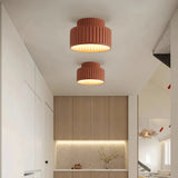 Cream ribbed ceiling light producing warm white light
